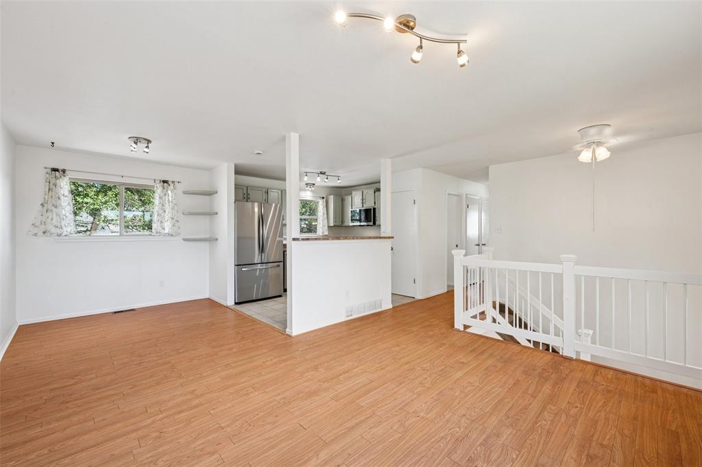 Image 12 of 33:  living room featuring healthy amount of natural light, light wood-style fl