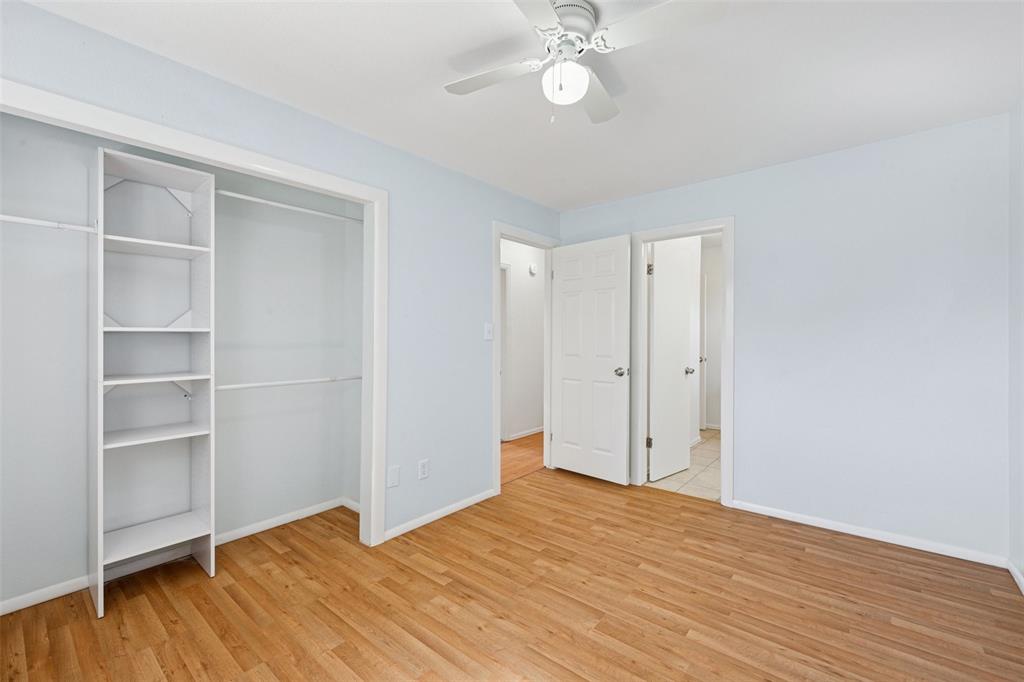 Image 16 of 33: bedroom with light wood-style floors, a closet, and ceiling fan