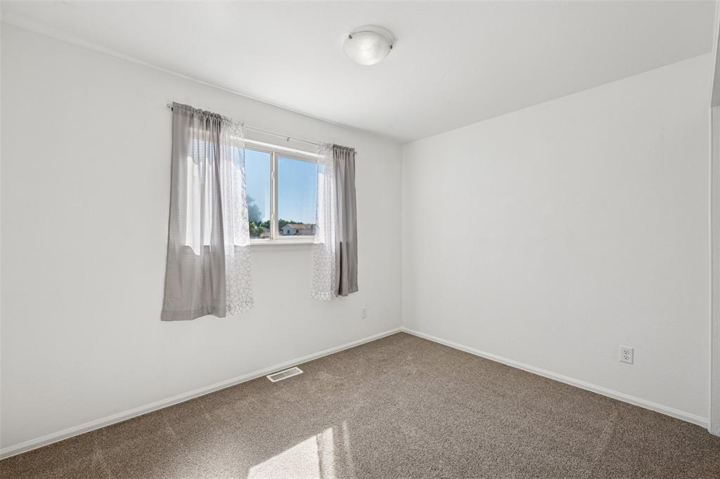 Image 17 of 33: Spare room with carpet floors and baseboards