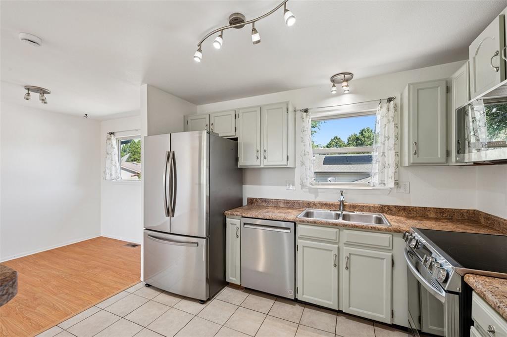 Image 5 of 33: Kitchen featuring appliances with stainless steel finishes, healthy amount 