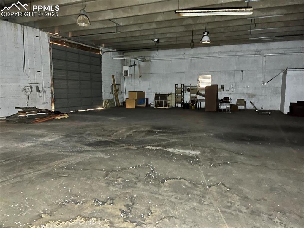 Image 14 of 23: Garage with concrete block wall