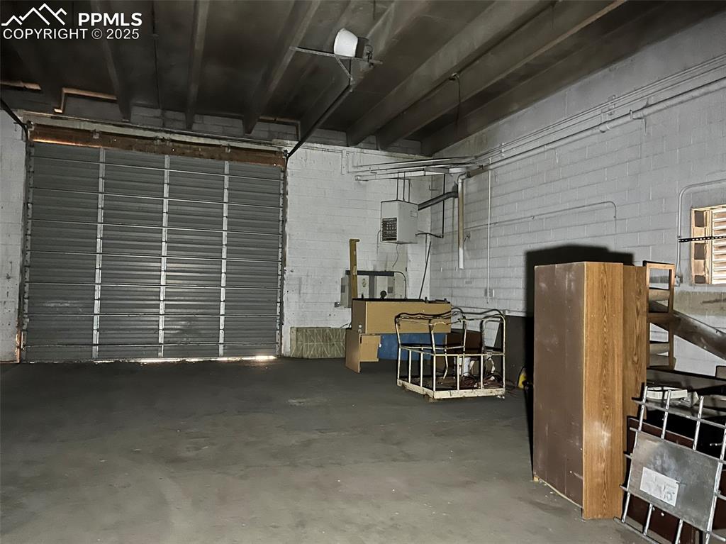 Image 20 of 23: Garage with concrete block wall