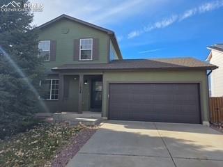 Image 4 of 44: New garage door, painted to match trim color