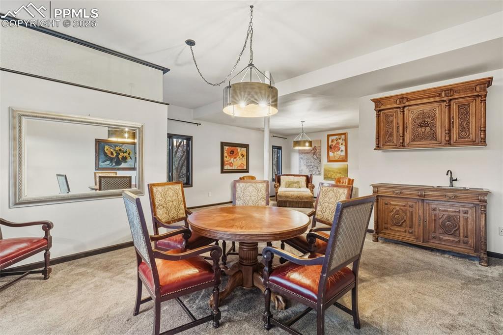 Image 32 of 46: Spacious walk out basement living room with wet bar. 