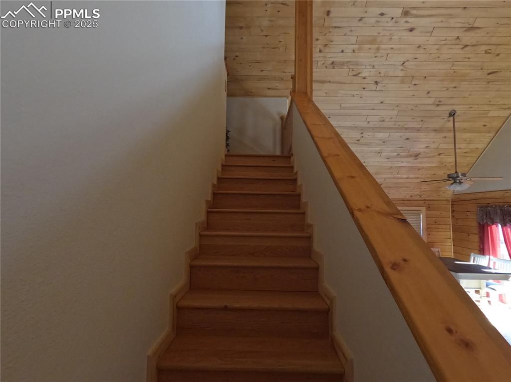 Image 21 of 23: Staircase featuring ceiling fan