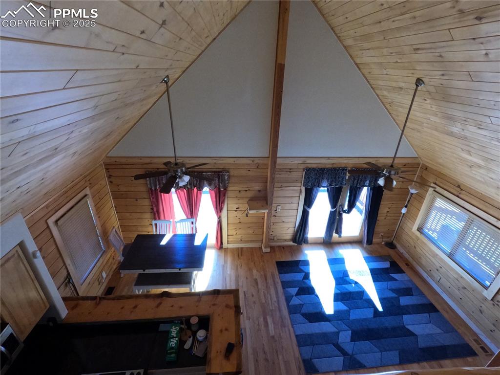 Image 23 of 23: Living area featuring wood walls, wood ceiling, plenty of natural light, hi
