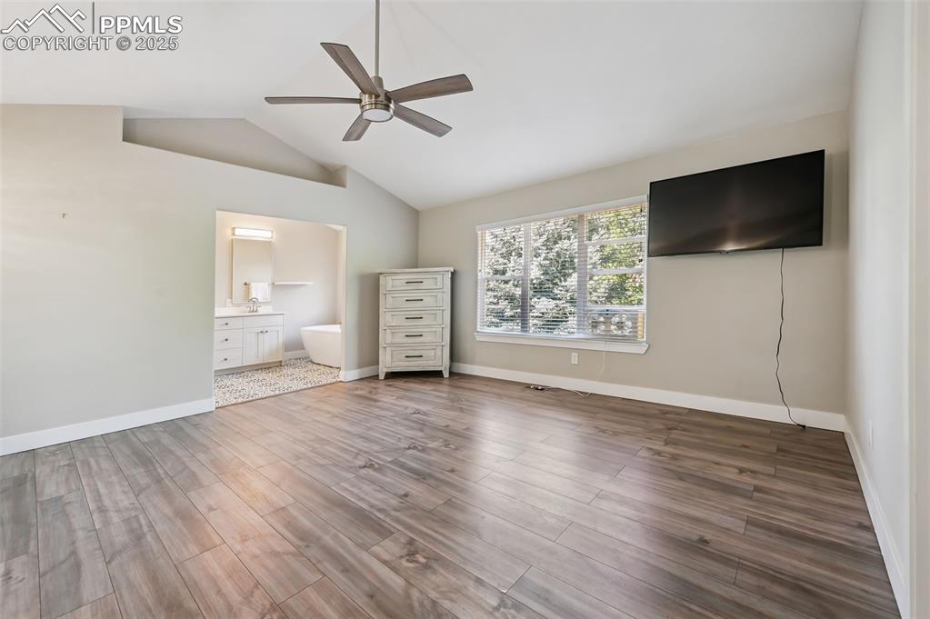 Image 17 of 39: Unfurnished bedroom featuring wood finished floors, ceiling fan, ensuite ba
