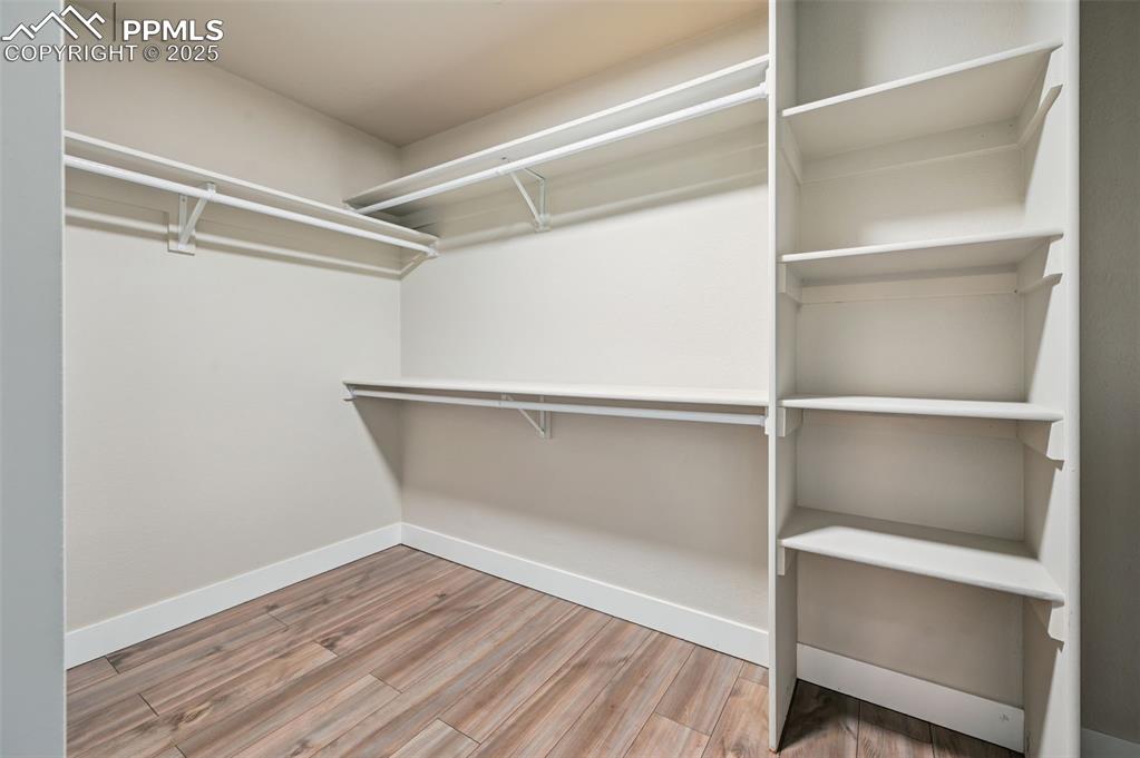 Image 18 of 39: Walk in closet featuring light wood-style floors