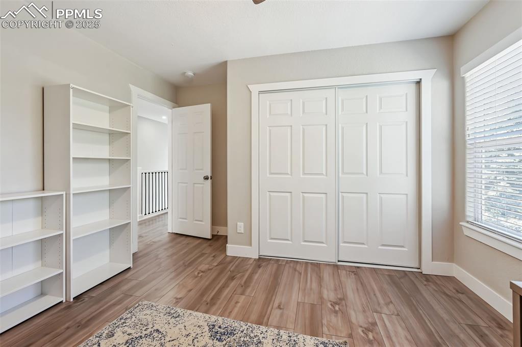 Image 23 of 39: Unfurnished bedroom featuring multiple windows, light wood finished floors,