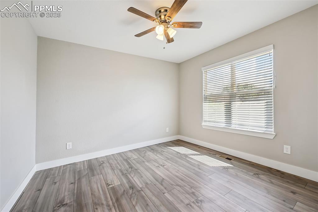 Image 27 of 39: Spare room featuring light wood-type flooring and ceiling fan