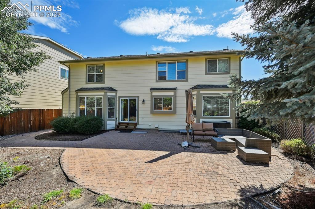 Image 37 of 39: Back of property with a patio area and an outdoor living space