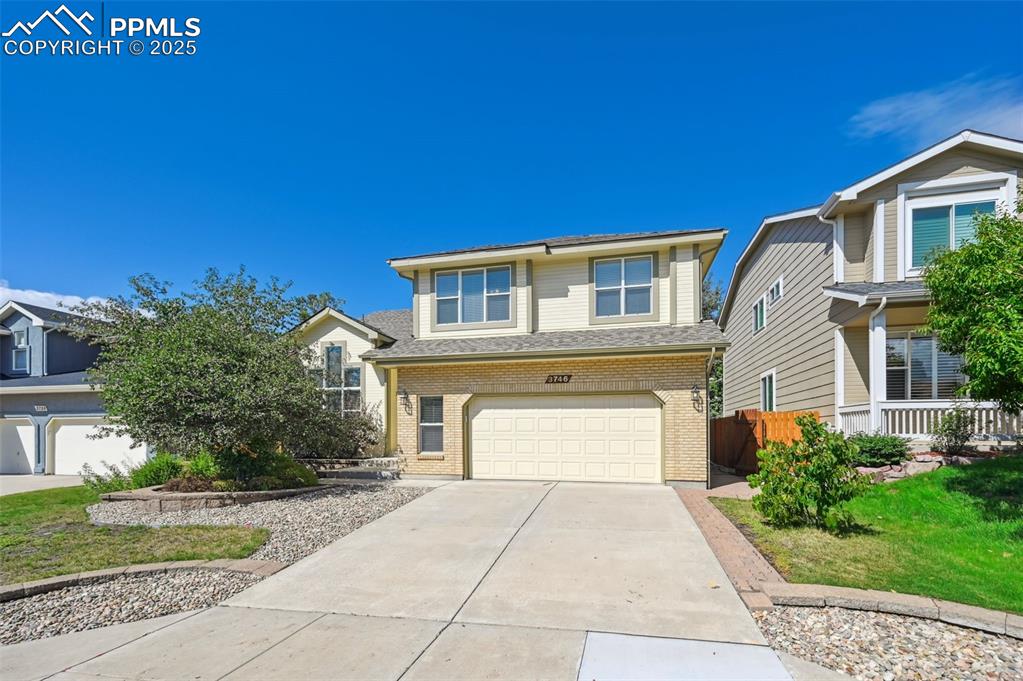 Image 41 of 41: Traditional-style home with brick siding, concrete driveway, a garage, a fr