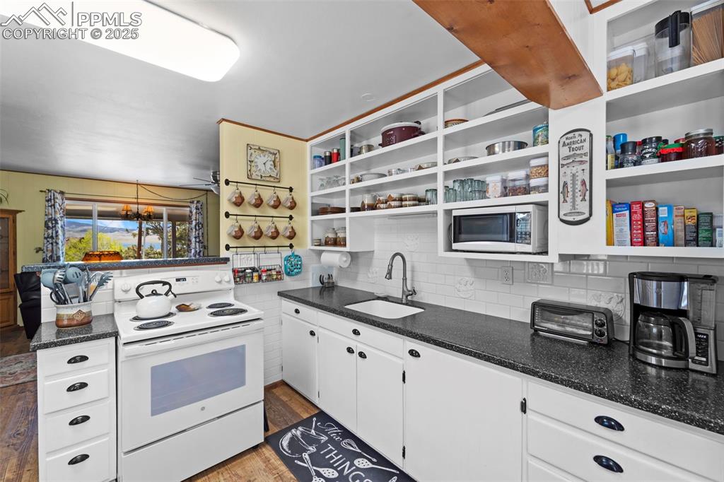 Image 16 of 31: Beautiful open shelving and custom backsplash.