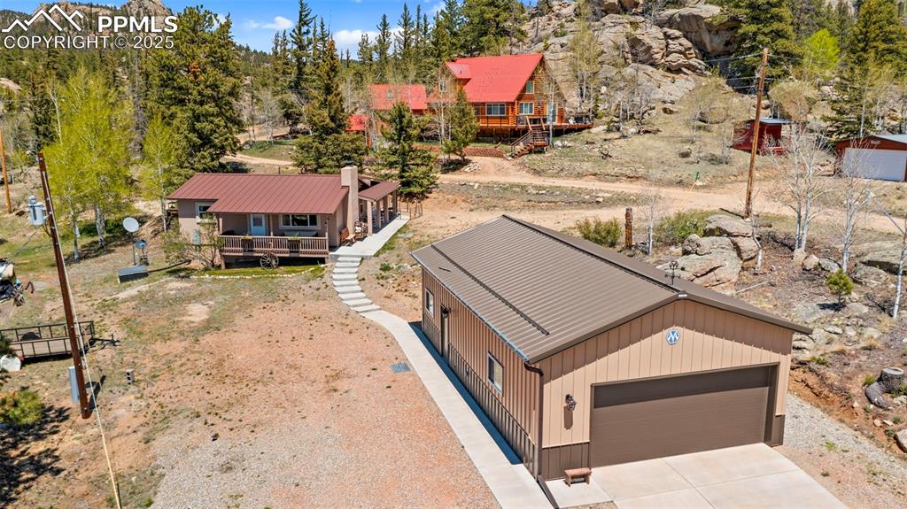 Image 3 of 31: Tucked away home and custom barn/garage with easy access.