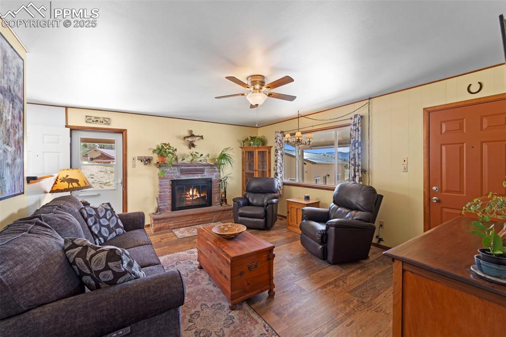 Image 7 of 31: Entry to cozy living room with picture window with water views and wood bur