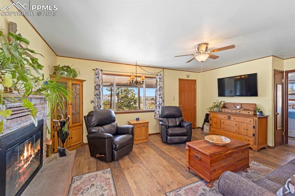 Image 8 of 31: Living room, wood fireplace and water views.