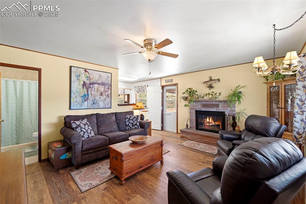 Image 9 of 31: Living room, side door and entry to kitchen.