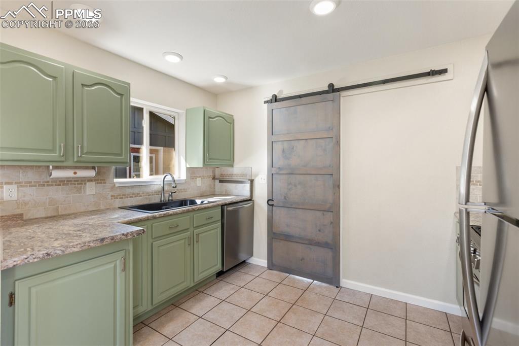 Image 13 of 34: Barn Door to Laundry Area