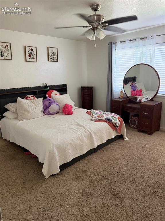Image 11 of 21: Ceiling fan with integrated lighting, window with blinds and sheer curtains