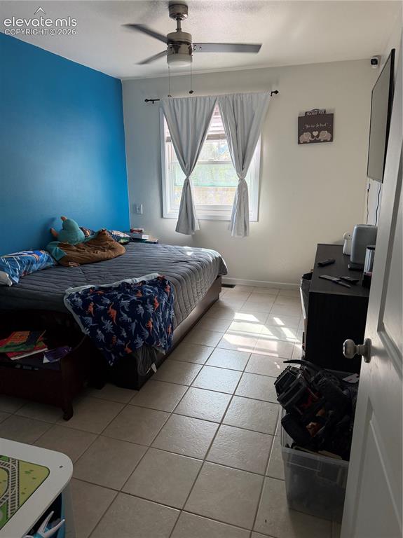 Image 13 of 21: Recessed window with drapes, ceiling fan with light fixture, light-toned ti