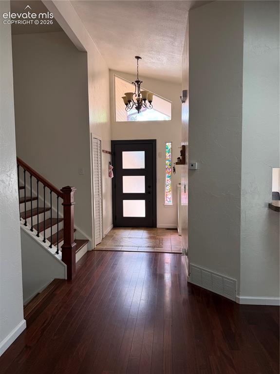 Image 2 of 21: Wood-finish flooring throughout, featuring a staircase with wood risers and