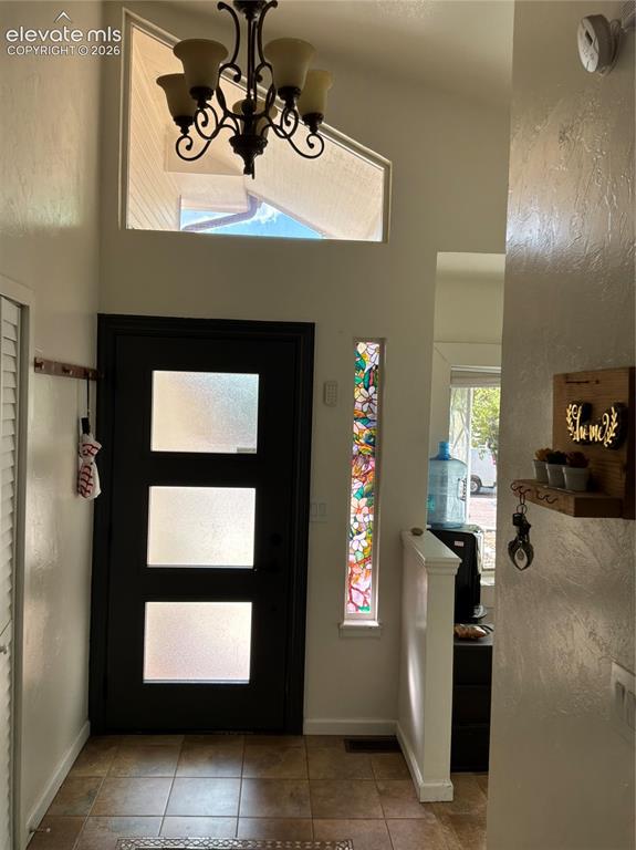 Image 6 of 21: Entryway with tile flooring, a modern door featuring three frosted glass pa