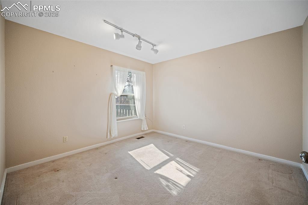 Image 34 of 50: Upper level bedroom.