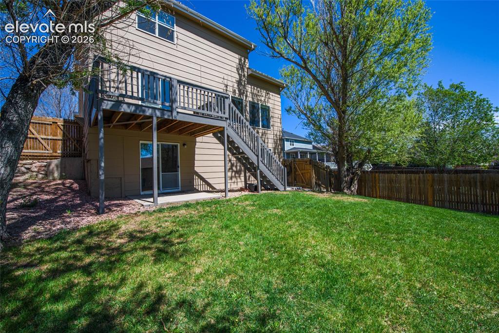 Image 2 of 42: Large fenced yard and home sits on cul-de-sac