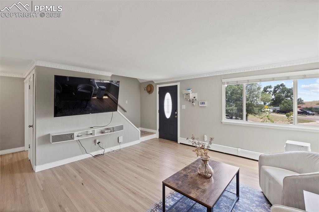 Image 3 of 33: Living room featuring wood finished floors