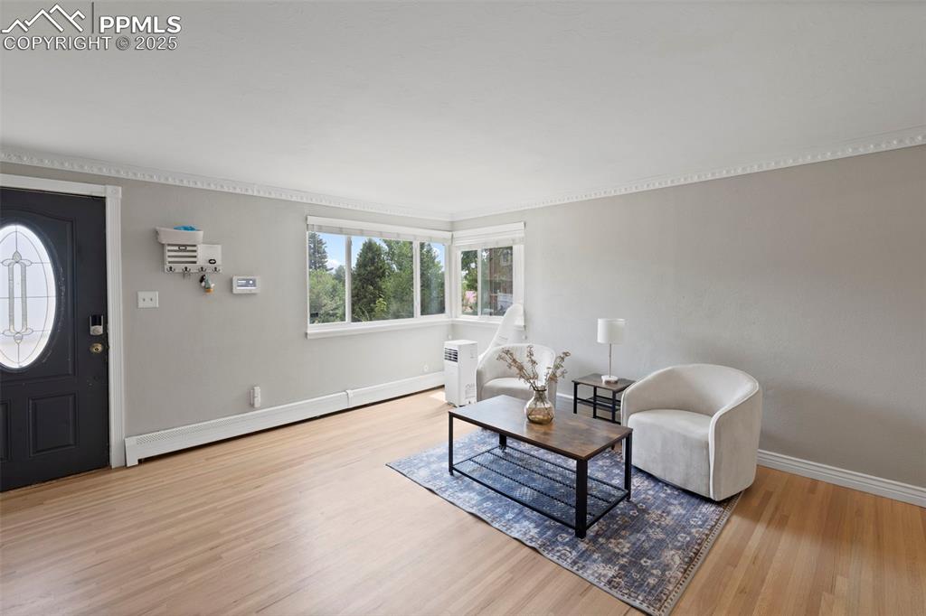 Image 4 of 33: Entryway with wood finished floors and baseboards