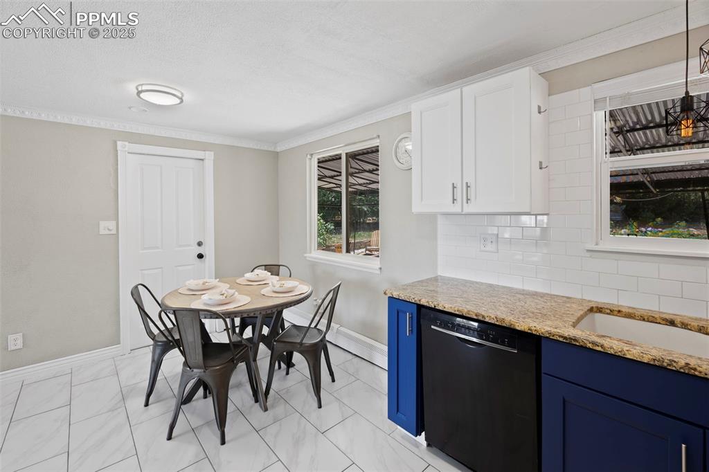 Image 8 of 33: Dining area with ornamental molding and baseboards