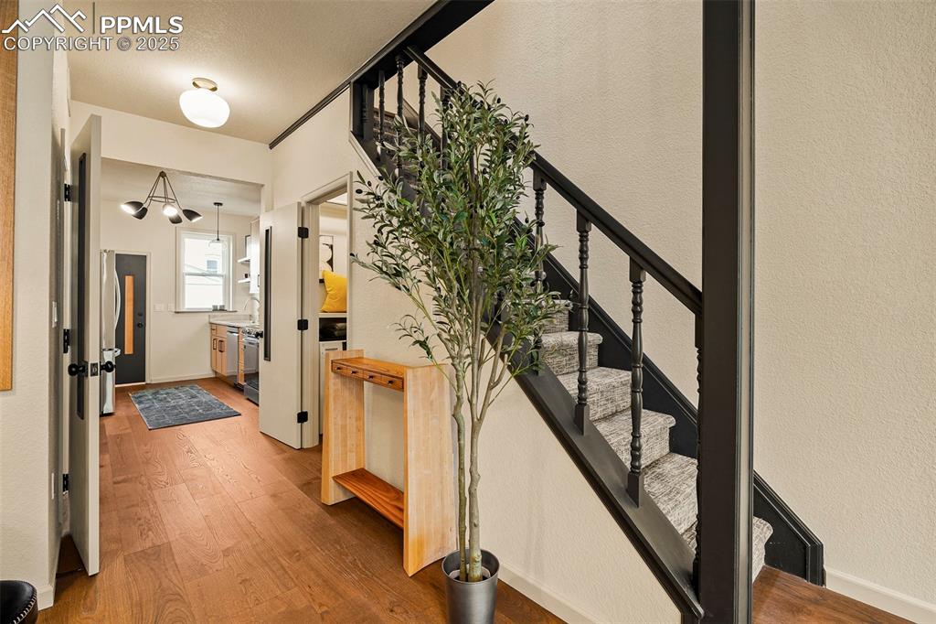 Image 11 of 47: Main level hallway area gives way to the dining room, main level powder roo
