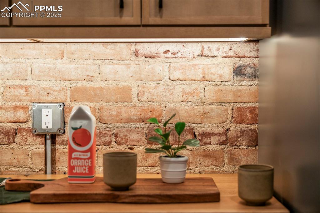 Image 17 of 47: Exposed original brick and under-cabinet lighting are just a few of the won