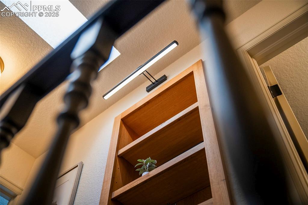 Image 20 of 47: Another custom built-in graces the 2nd level hallway.