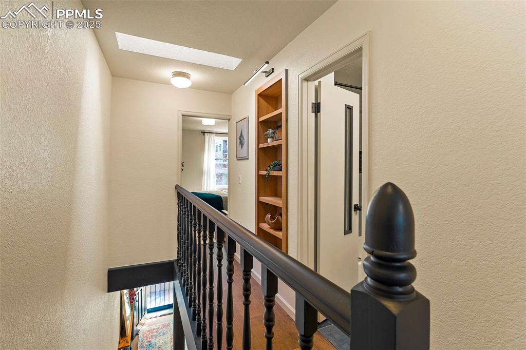 Image 21 of 47: Another custom built-in graces the 2nd level hallway.