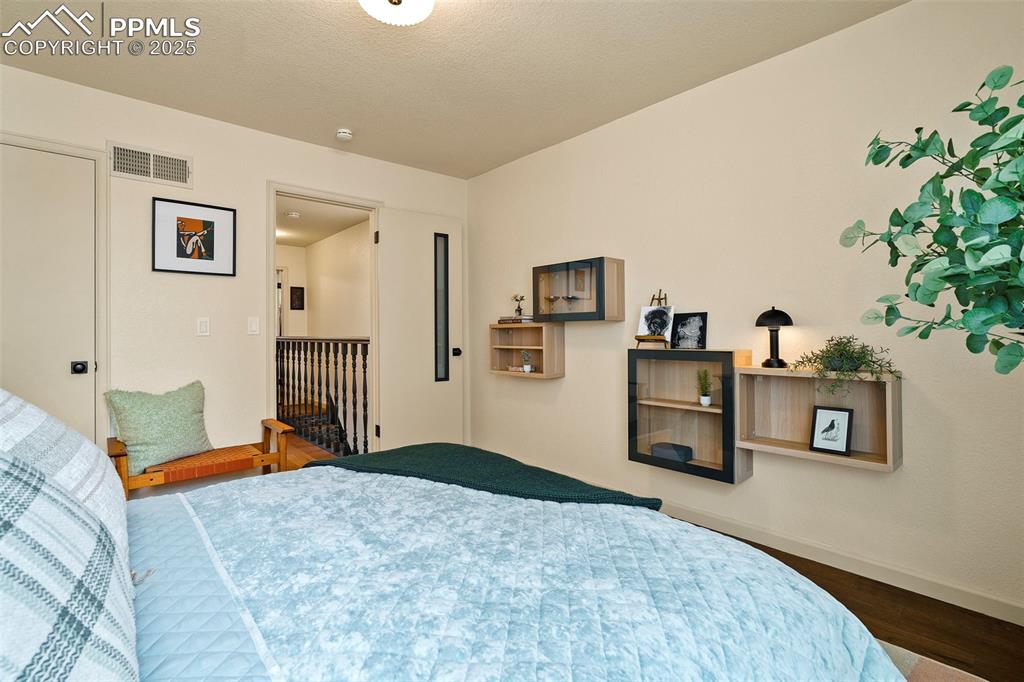 Image 22 of 47: Large front bedroom has beautiful natural light through a large front windo