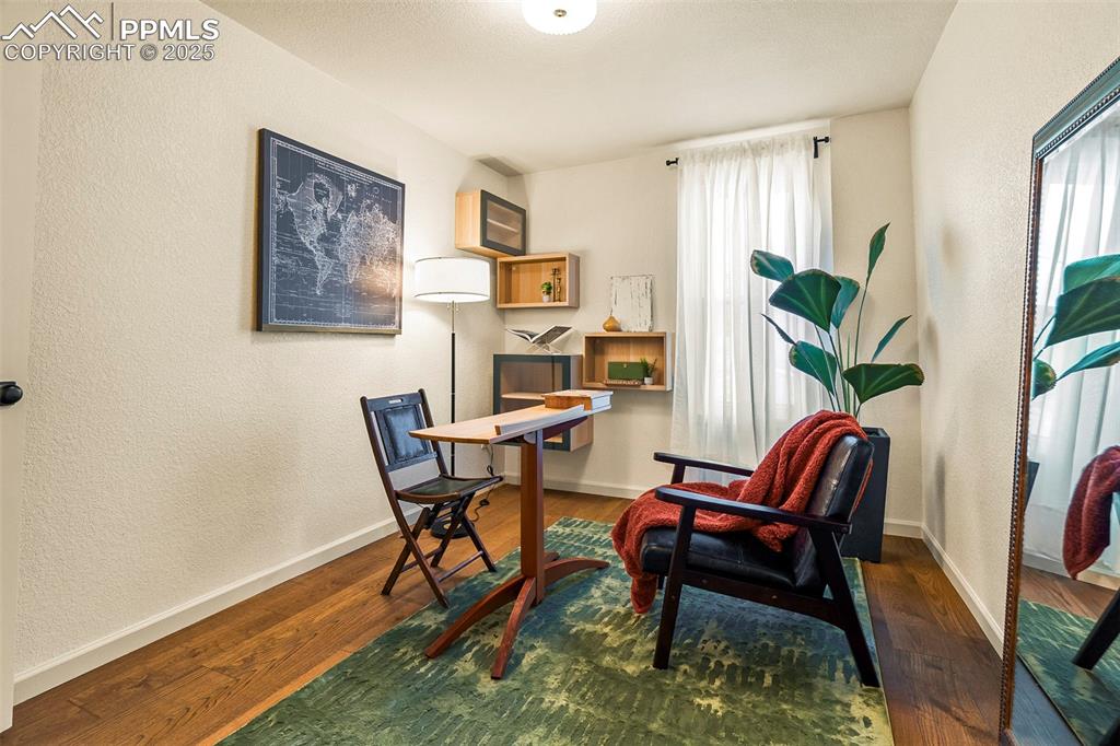 Image 25 of 47: Second bedroom, staged as an office, is also decorated with extra open and 