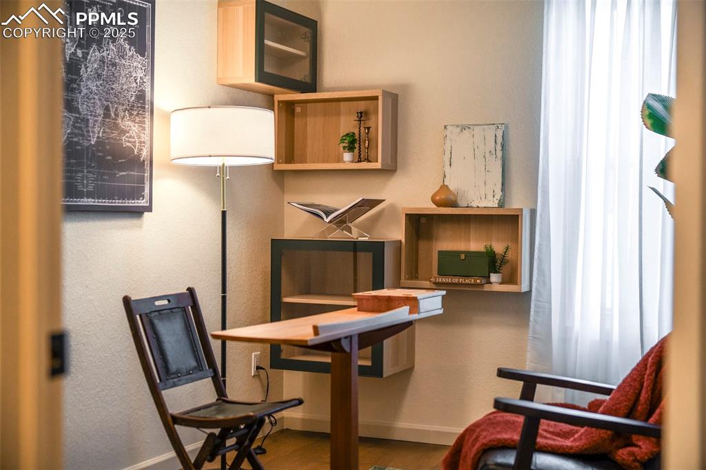 Image 26 of 47: Second bedroom, staged as an office, is also decorated with extra open and 