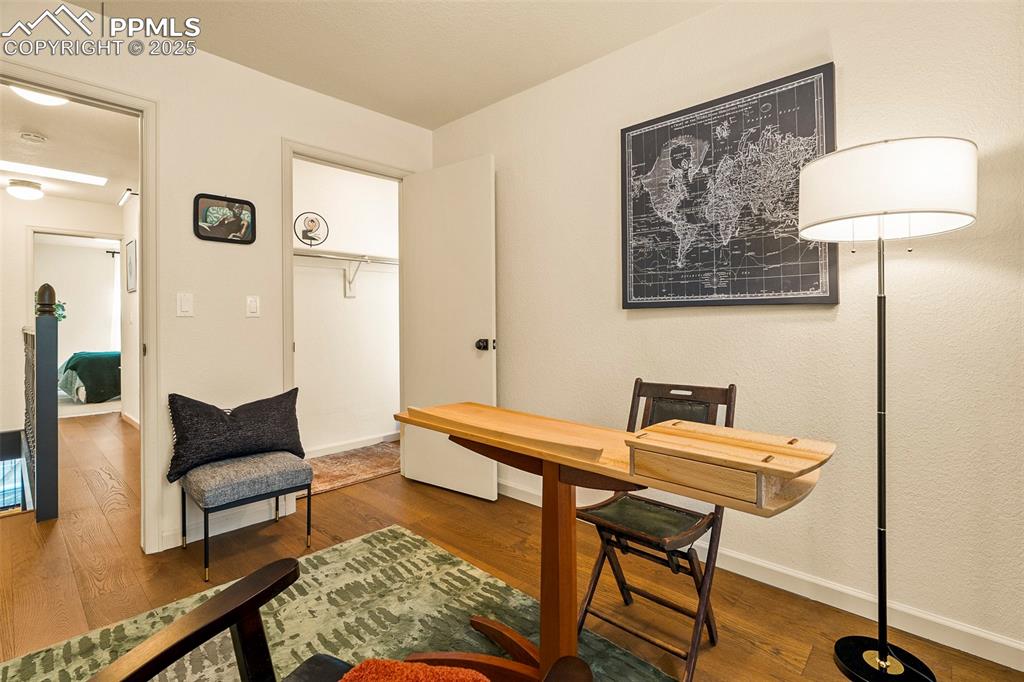 Image 27 of 47: Second bedroom, staged as an office, is also decorated with extra open and 