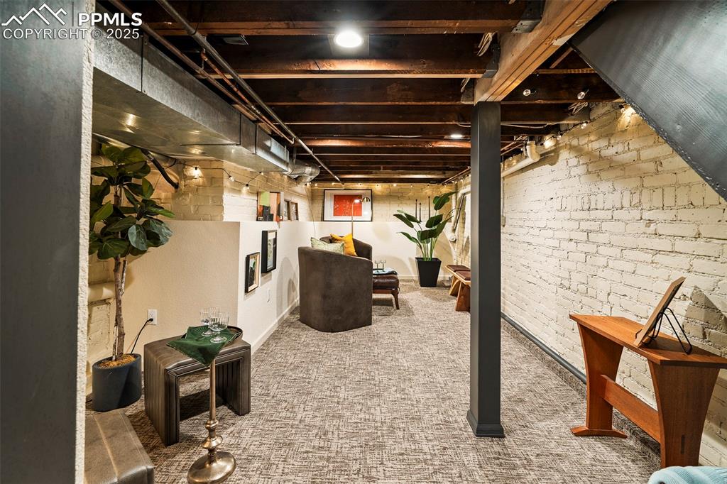 Image 32 of 47: The basement family room celebrates the history of the original structure w