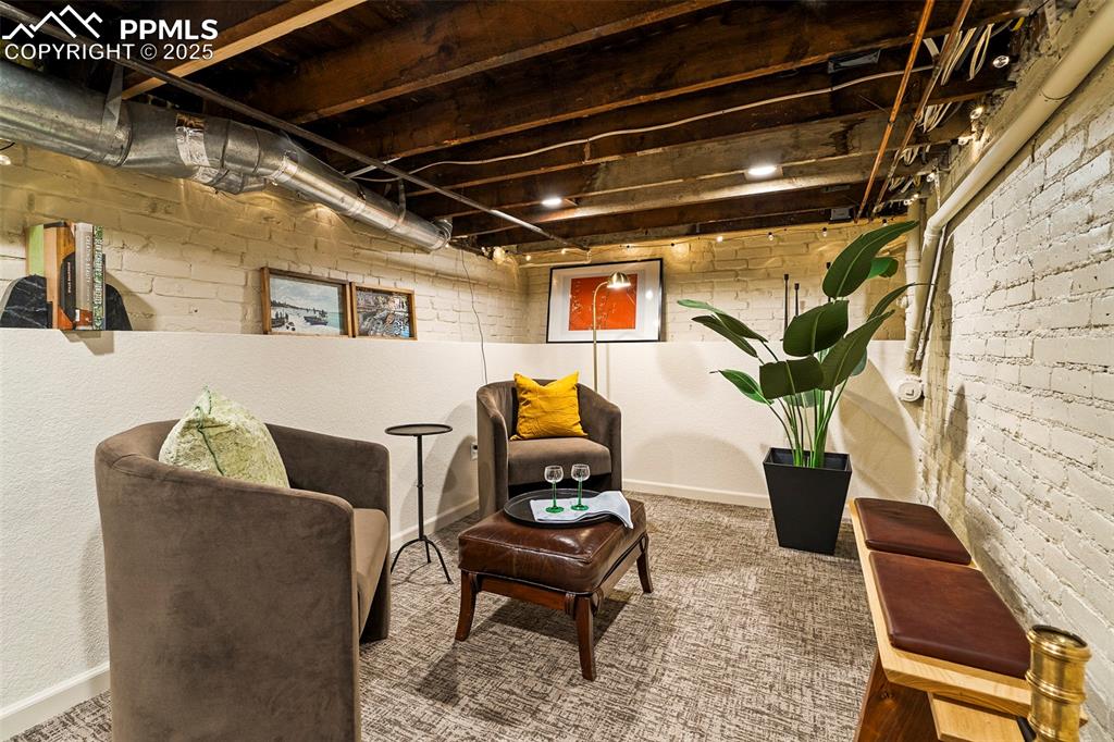 Image 33 of 47: The basement family room celebrates the history of the original structure w