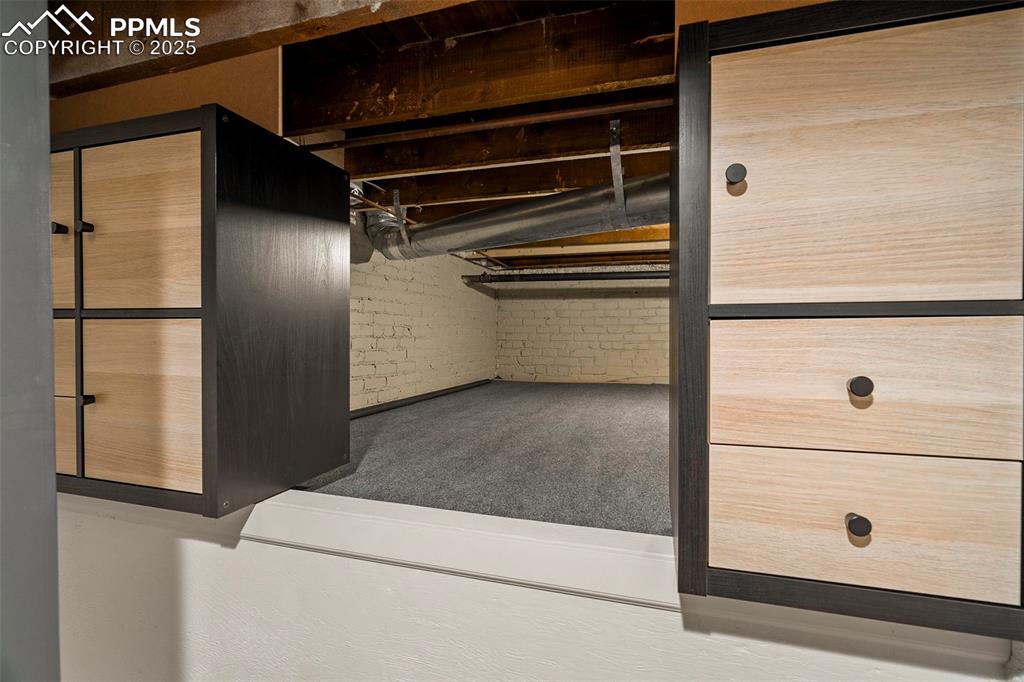 Image 35 of 47: The basement family room celebrates the history of the original structure w