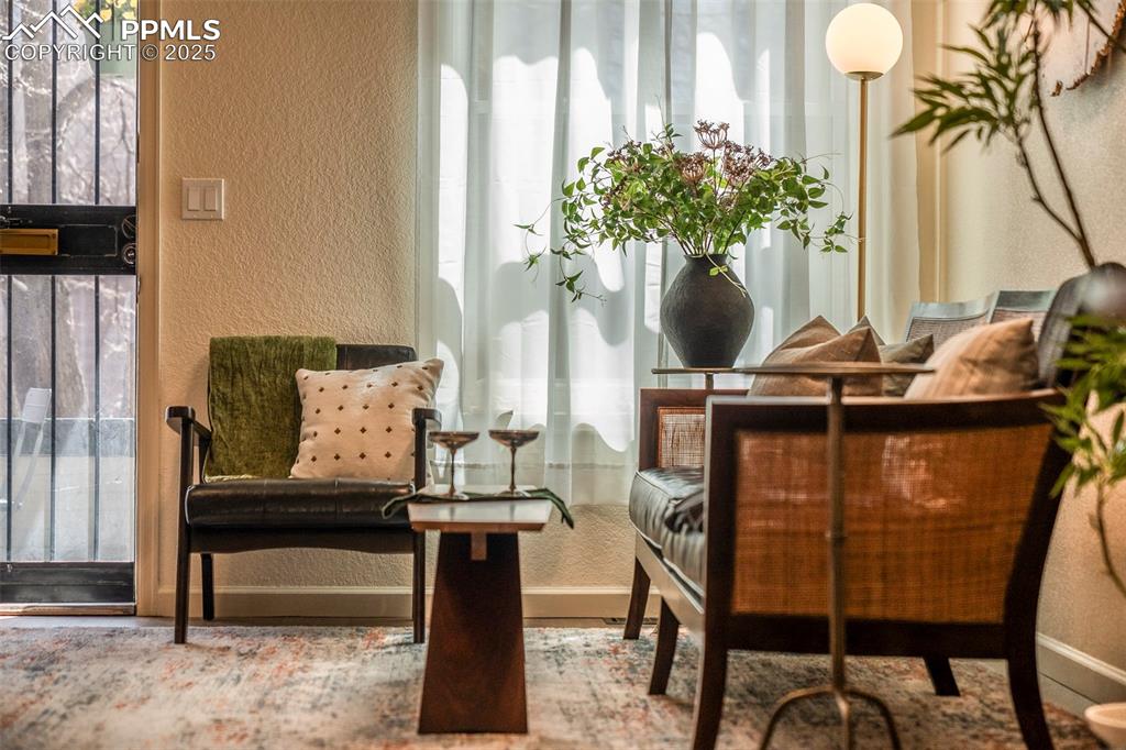 Image 7 of 47: The open living room is a sunlit gathering space, as well as an elegant rec