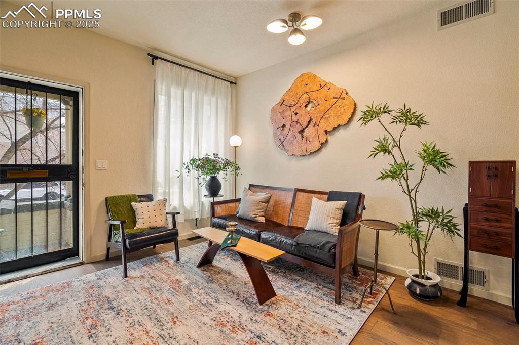 Image 8 of 47: The open living room is a sunlit gathering space, as well as an elegant rec