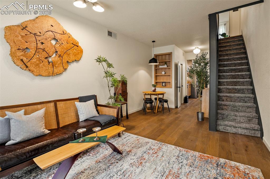 Image 9 of 47: The open living room is a sunlit gathering space, as well as an elegant rec