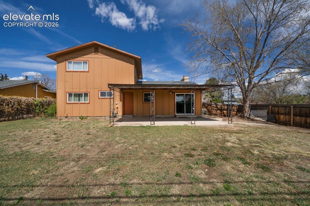 Image 2 of 25: Backyard featuring a concrete patio, sliding glass door access, wood privac