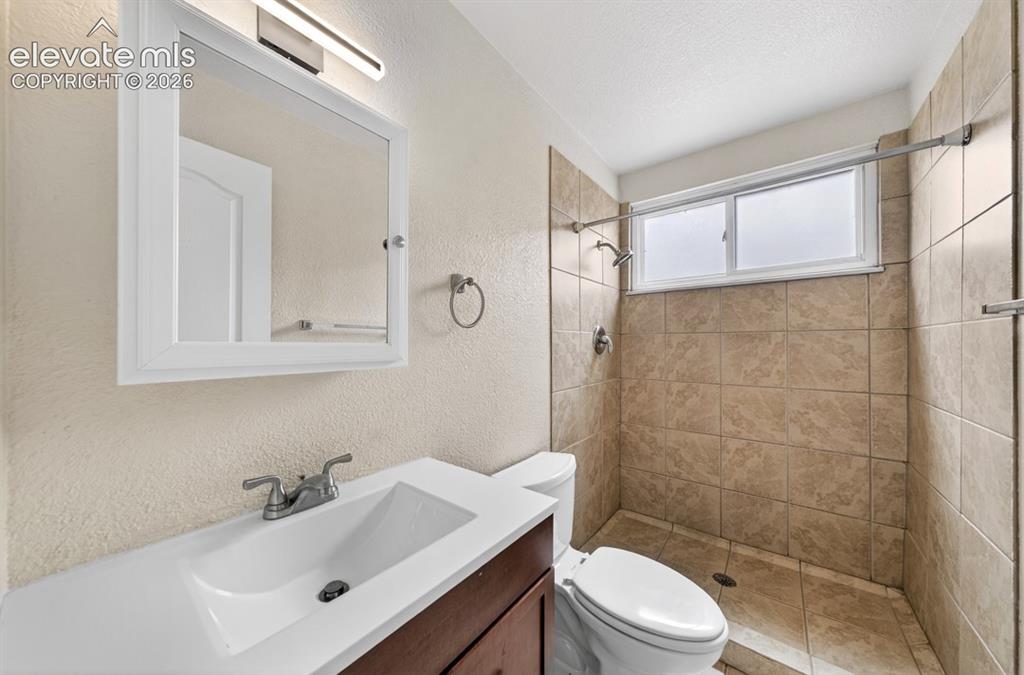 Image 23 of 25: Vanity with integrated sink and chrome faucet