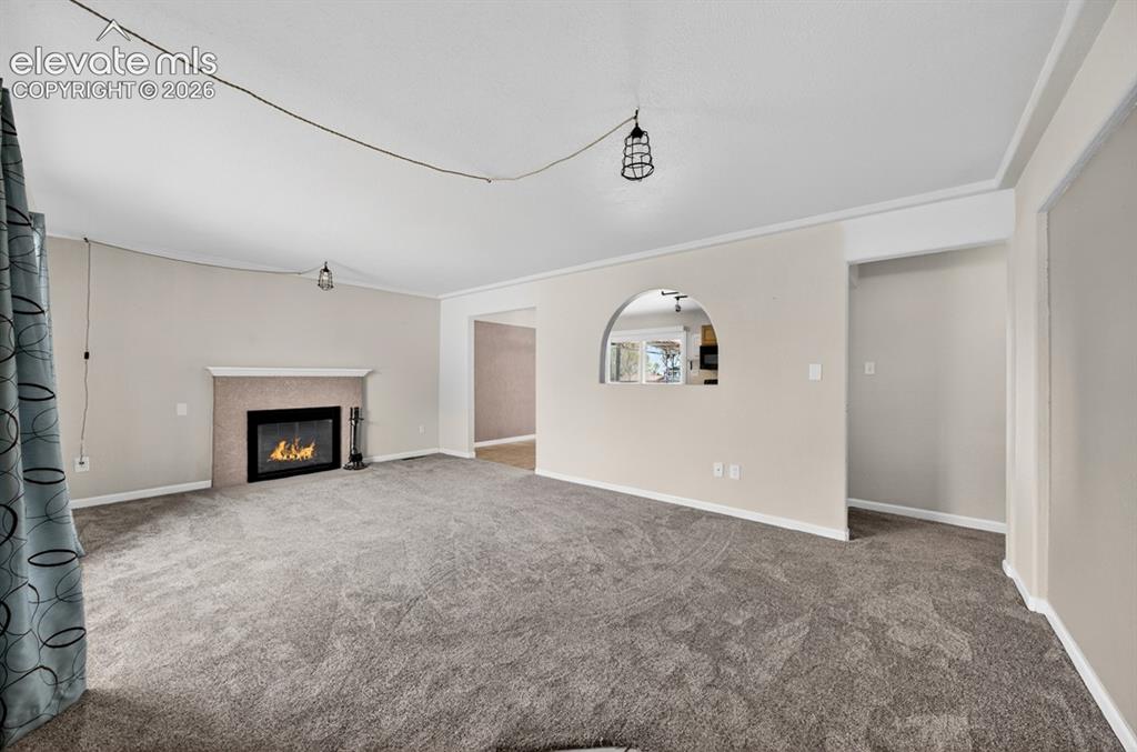 Image 6 of 25: Stone-clad fireplace with mantel, recessed firebox, and a hearth