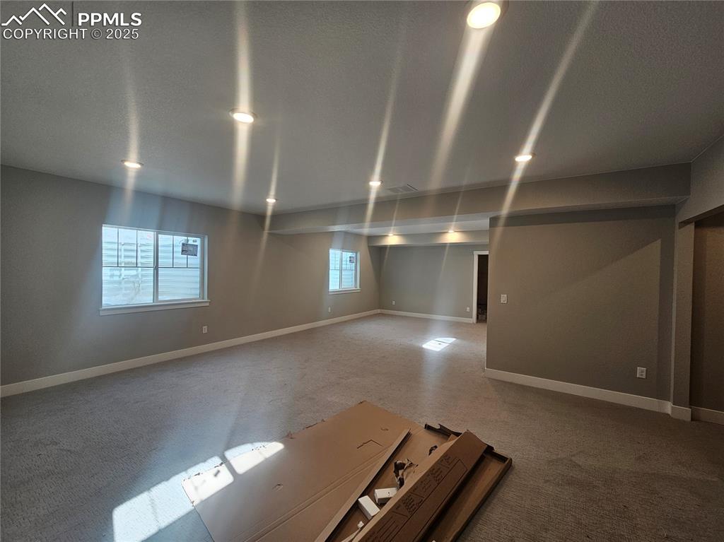 Image 21 of 21: Basement with carpet flooring