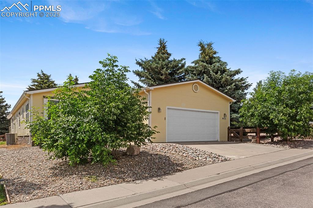 Image 2 of 24: Obstructed view of property featuring driveway and a garage